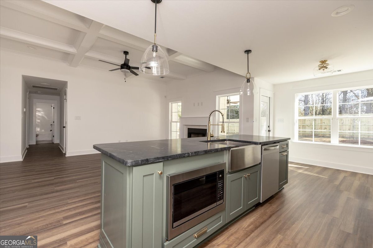 506 New Hope Drive Perry, GA 31069 - Photo 18 of 51 a kitchen with stainless steel appliances granite countertop a sink a stove and a wooden floors