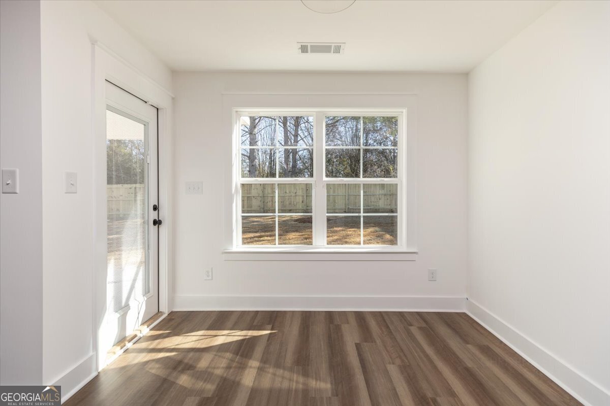 506 New Hope Drive Perry, GA 31069 - Photo 20 of 51 an empty room with wooden floor and windows