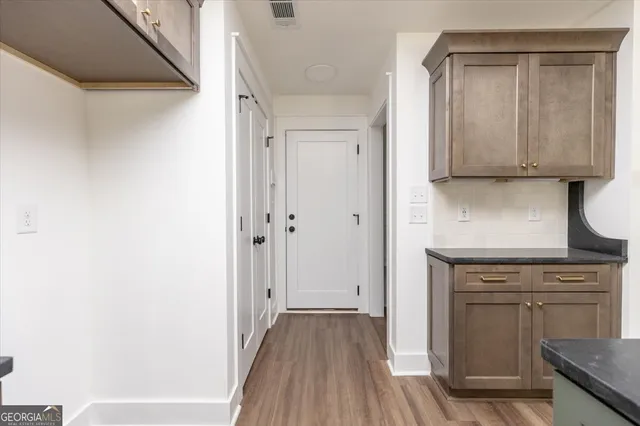 a kitchen with a refrigerator and a stove top oven