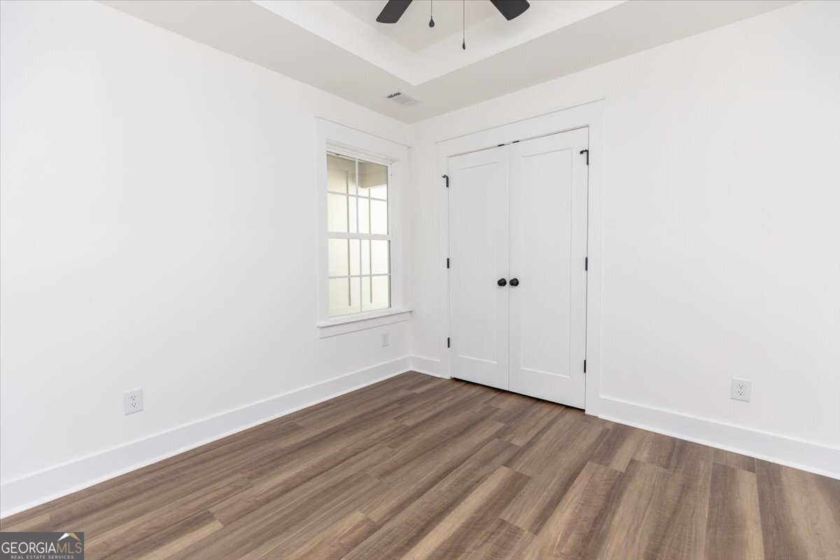 506 New Hope Drive Perry, GA 31069 - Photo 35 of 51 an empty room with wooden floor and windows