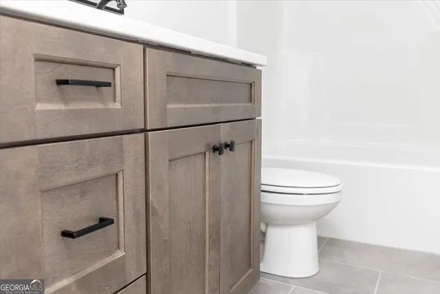 a white toilet sitting next to a bathroom sink