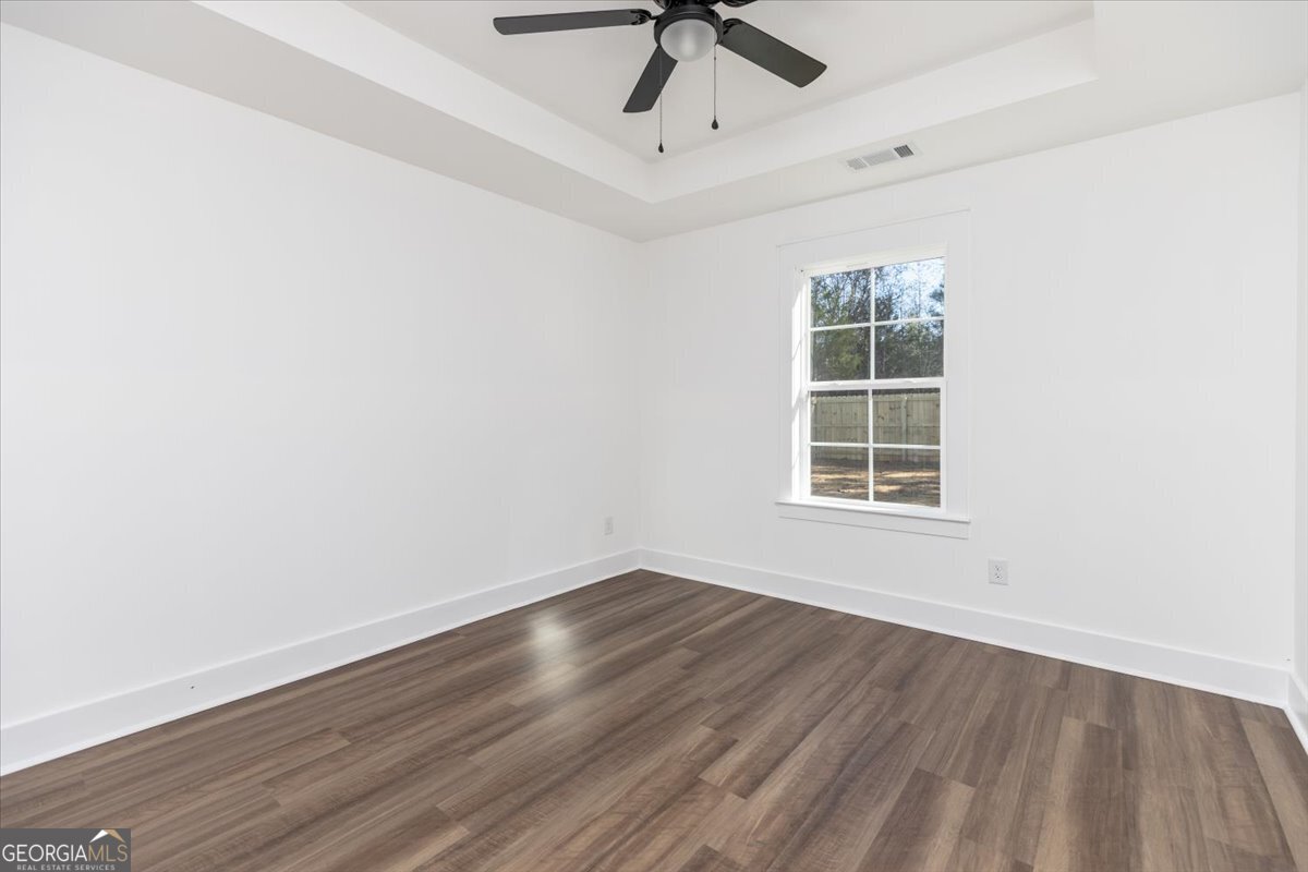 506 New Hope Drive Perry, GA 31069 - Photo 43 of 51 an empty room with wooden floor cabinet and windows