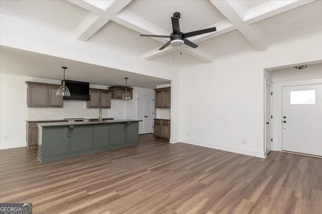 a room with a wooden floor and a ceiling fan