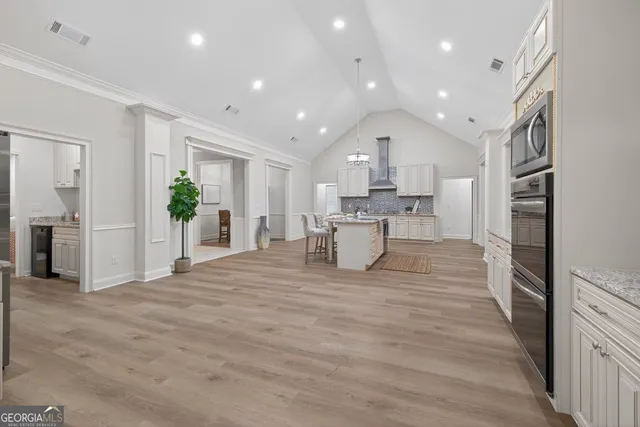 a bedroom with a large bed potted plant and a window