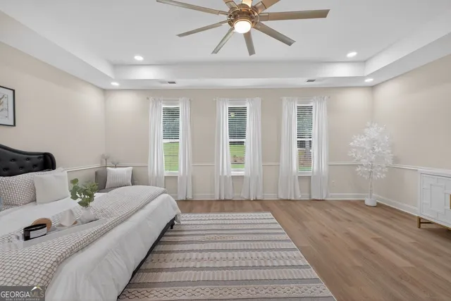 a bathroom with a granite countertop sink a toilet and shower
