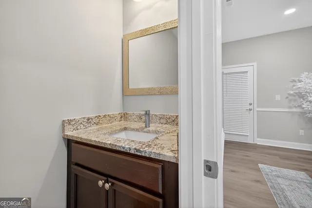 a view of a house with a yard and large trees