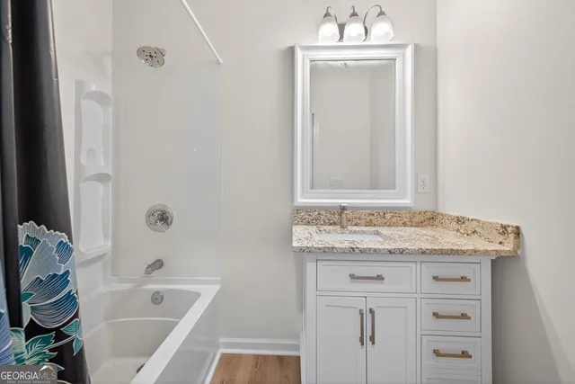 an aerial view of a house with a yard basket ball court and outdoor seating