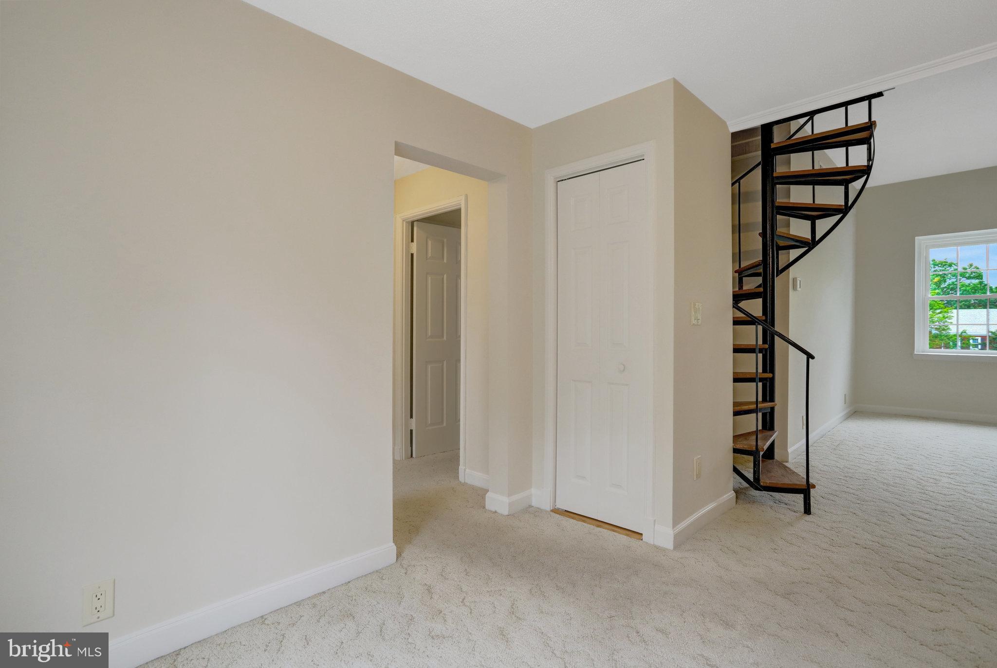 3062 South Buchanan Street, Unit C2 Arlington, VA 22206 - Photo 11 of 33 an empty room with windows and stairs