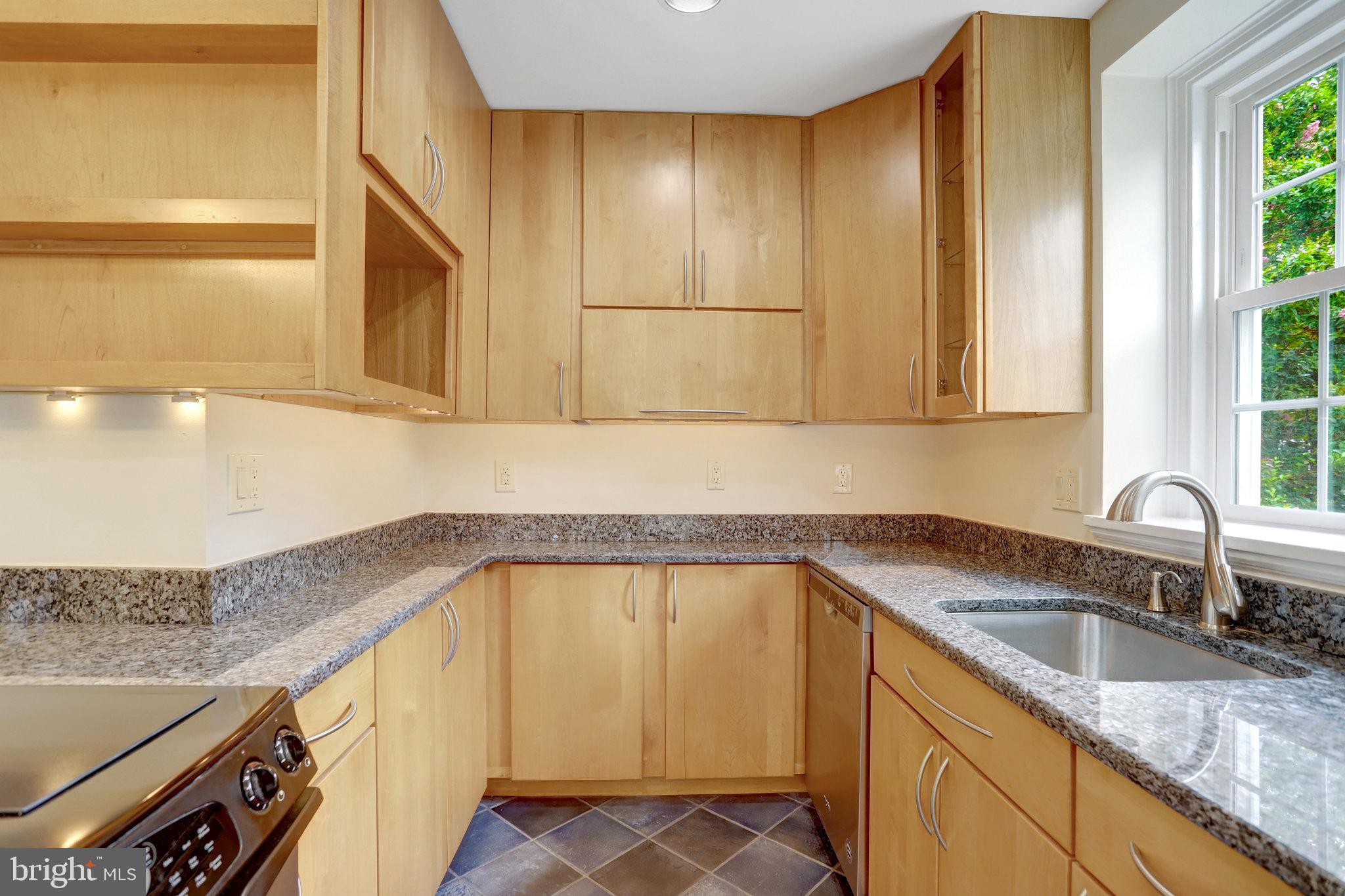3062 South Buchanan Street, Unit C2 Arlington, VA 22206 - Photo 13 of 33 a kitchen with granite countertop sink and cabinets