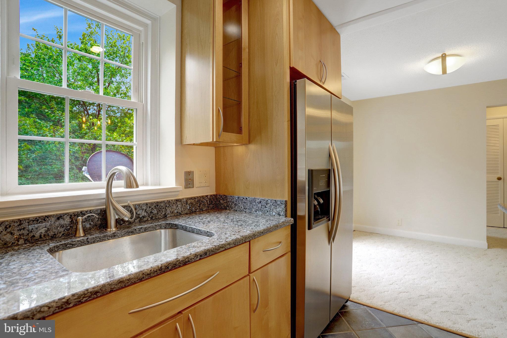3062 South Buchanan Street, Unit C2 Arlington, VA 22206 - Photo 15 of 33 a bathroom with a granite countertop sink and a large mirror