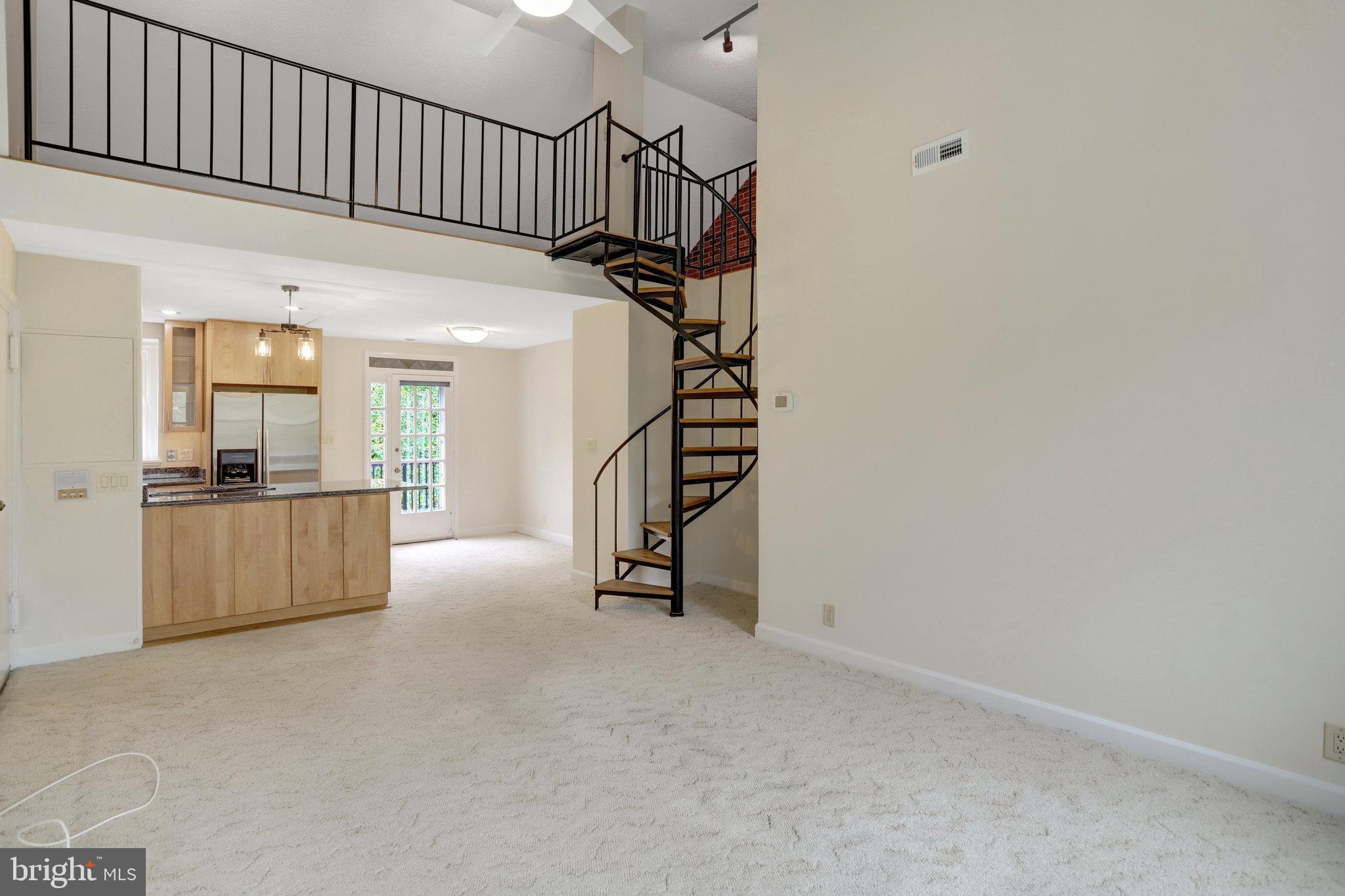 3062 South Buchanan Street, Unit C2 Arlington, VA 22206 - Photo 4 of 33 a view of an empty room with wooden floor and stairs