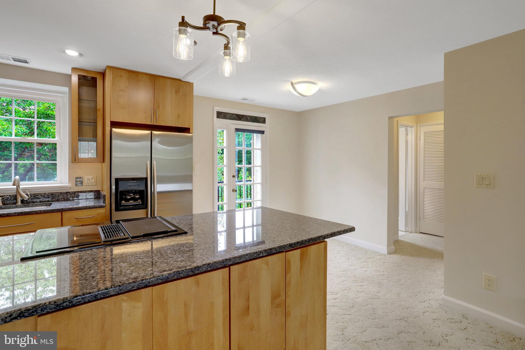 3062 South Buchanan Street, Unit C2 Arlington, VA 22206 - Photo 6 of 33 a kitchen with stainless steel appliances granite countertop a refrigerator a sink and a stove with wooden floor