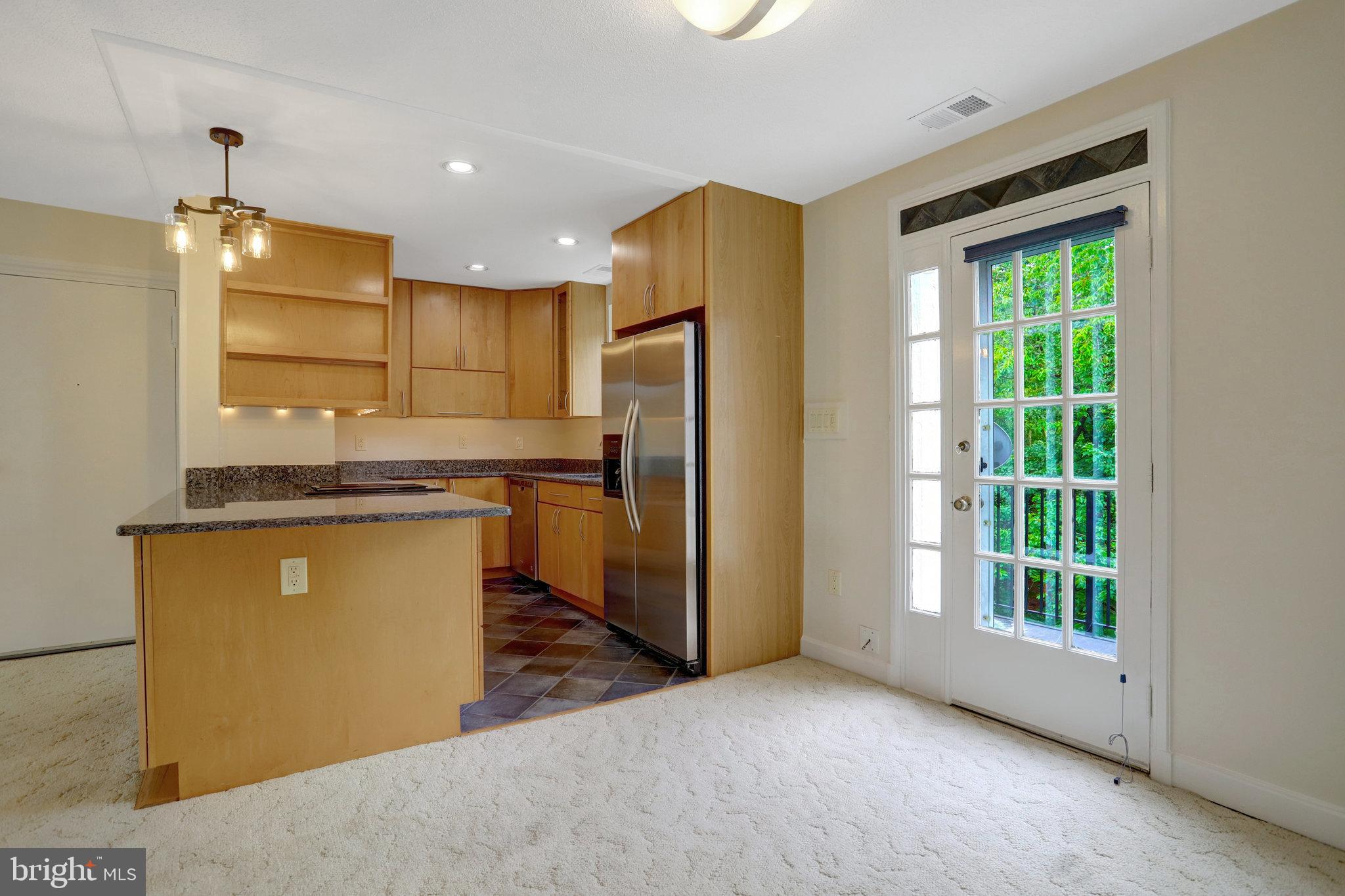 3062 South Buchanan Street, Unit C2 Arlington, VA 22206 - Photo 9 of 33 a kitchen with stainless steel appliances granite countertop a refrigerator a sink a stove and a refrigerator