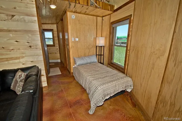 a bedroom with a bed and a mirror