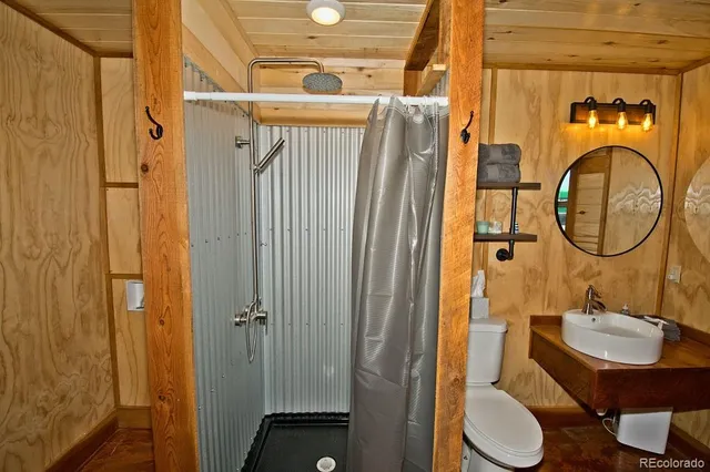 a bathroom with a toilet a sink and a mirror