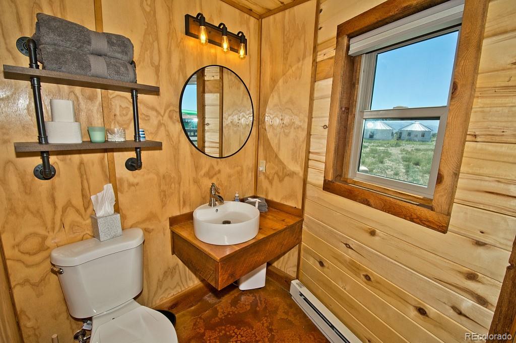 426 Shakedown Street Moffat, CO 81143 - Photo 15 of 17 a bathroom with a toilet sink and mirror