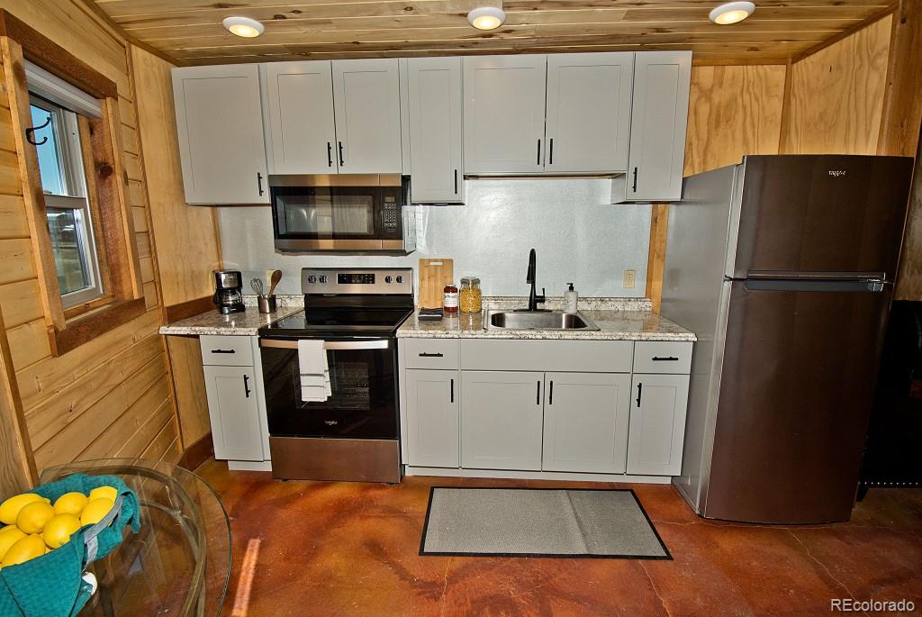 426 Shakedown Street Moffat, CO 81143 - Photo 3 of 17 a kitchen with a refrigerator sink and stove