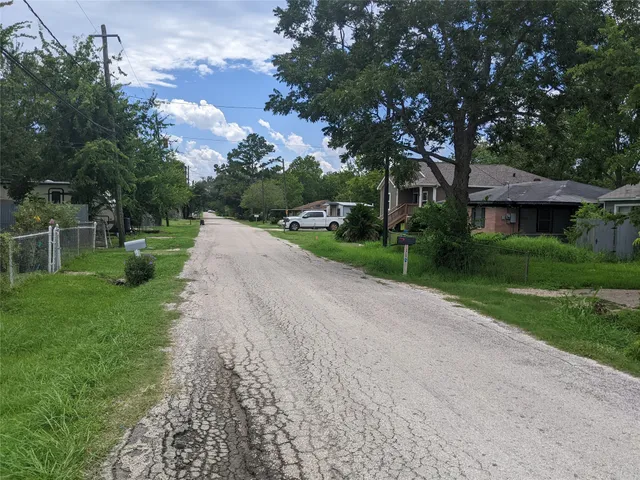 a green field with tree in the background