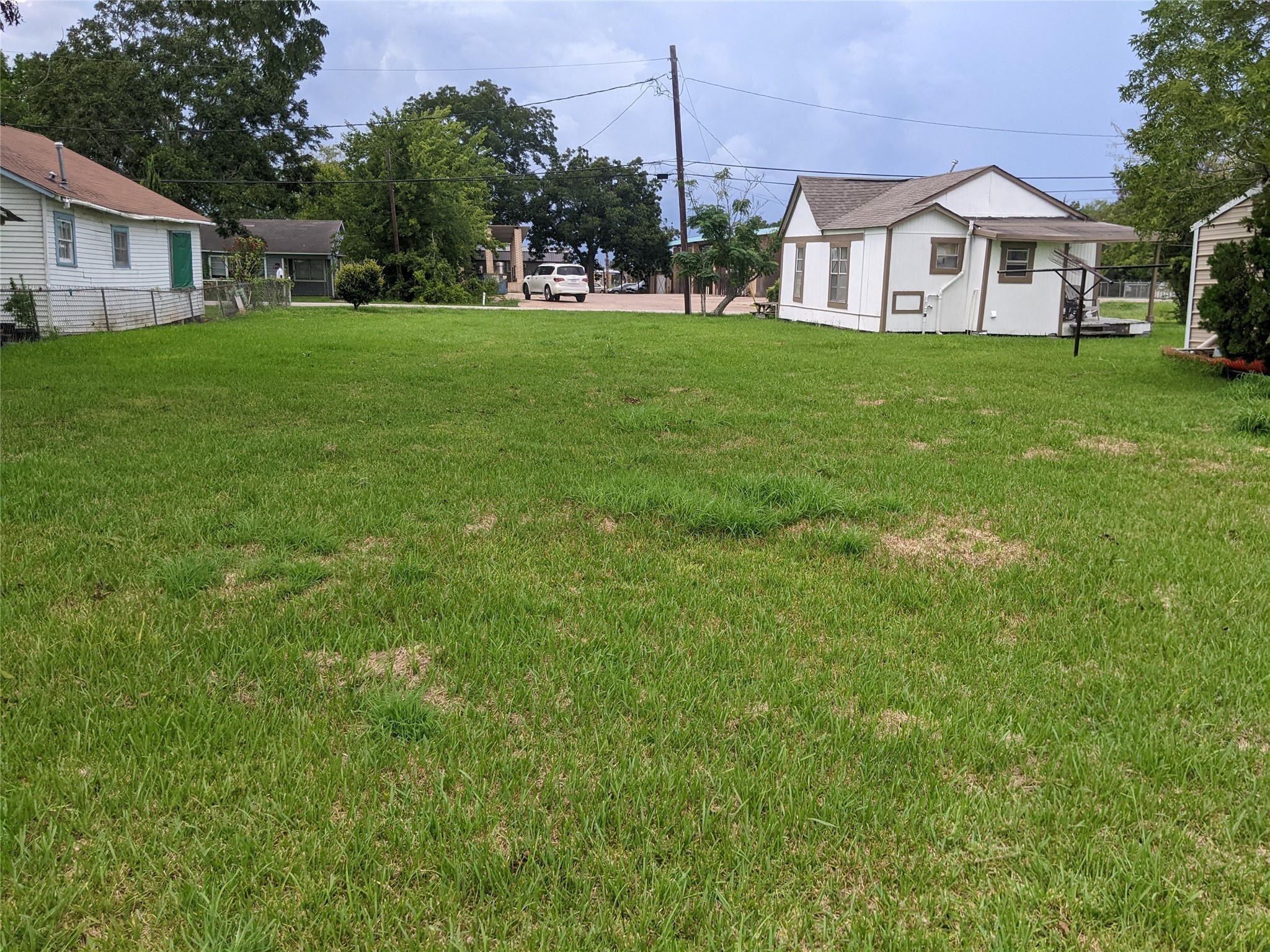 107 Correll Avenue Wharton, TX 77488 - Photo 4 of 8 a view of a house with a big yard plants and large trees