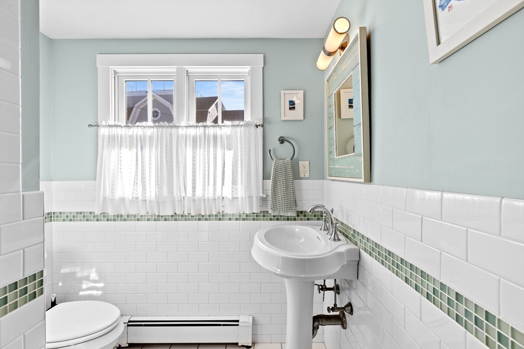 18 Collier Road Scituate, MA 02066 - Photo 14 of 40 a bathroom with a sink a toilet and a mirror