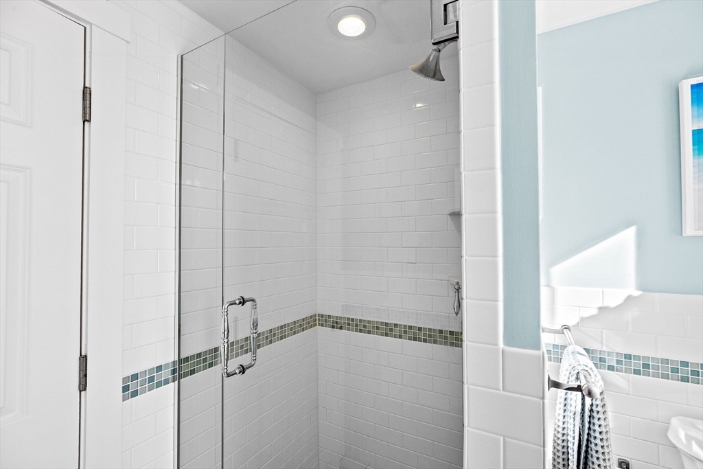 18 Collier Road Scituate, MA 02066 - Photo 15 of 40 a bathroom with a glass shower door