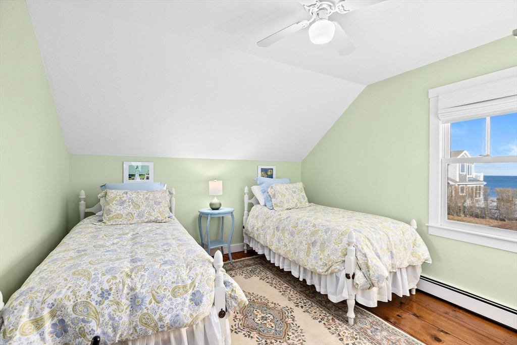 18 Collier Road Scituate, MA 02066 - Photo 20 of 40 a bedroom with a bed and a chandelier