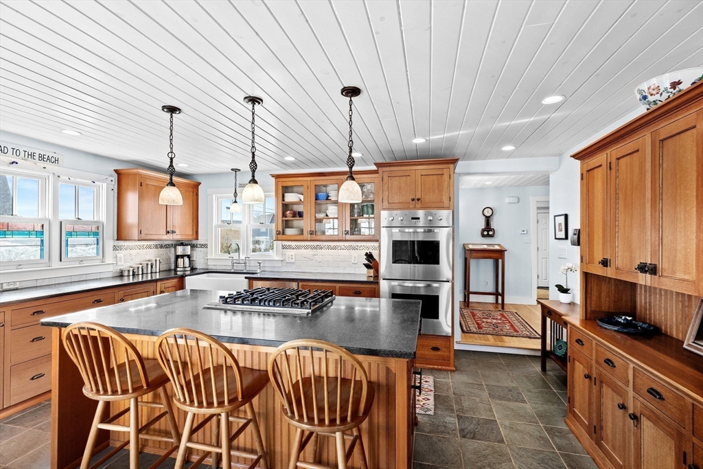 18 Collier Road Scituate, MA 02066 - Photo 10 of 40 a kitchen with stainless steel appliances granite countertop a stove top oven a sink dishwasher and white cabinets with wooden floor