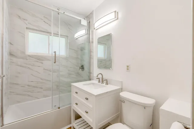 a bathroom with a sink toilet and shower