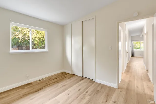 a view of a room with wooden floor and window