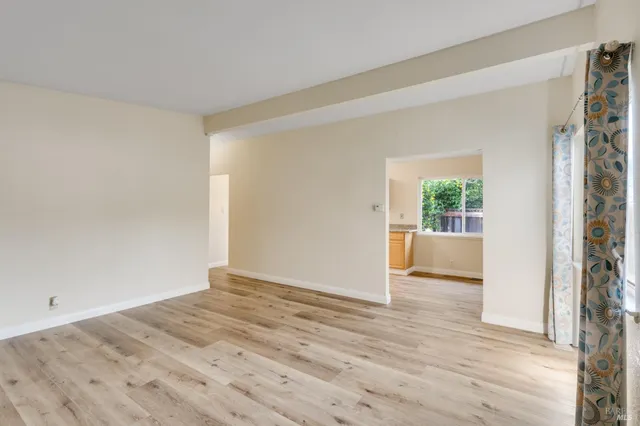 a view of a livingroom with wooden floor and a sink