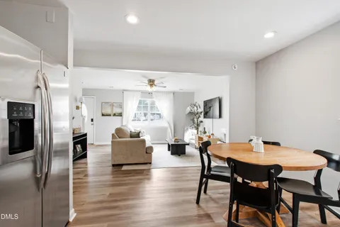 a dining room with furniture and wooden floor