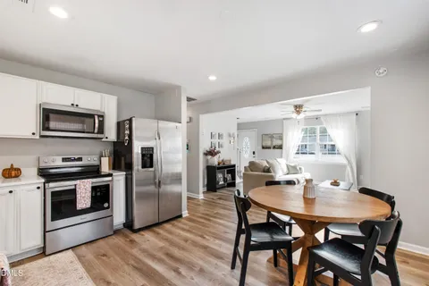 a dining room with furniture and wooden floor