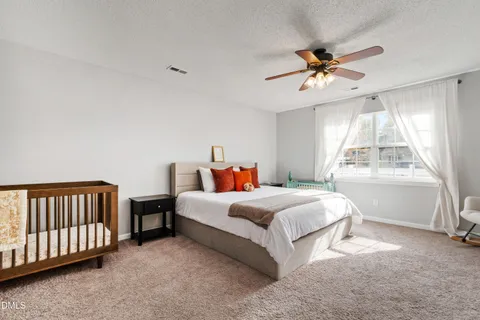 a spacious bedroom with a bed and a window