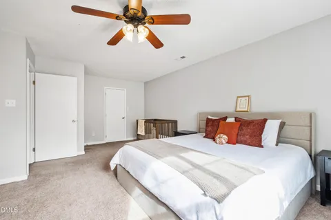 a bedroom with a bed and a ceiling fan