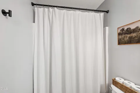 a bathroom with a shower curtain and a curtain