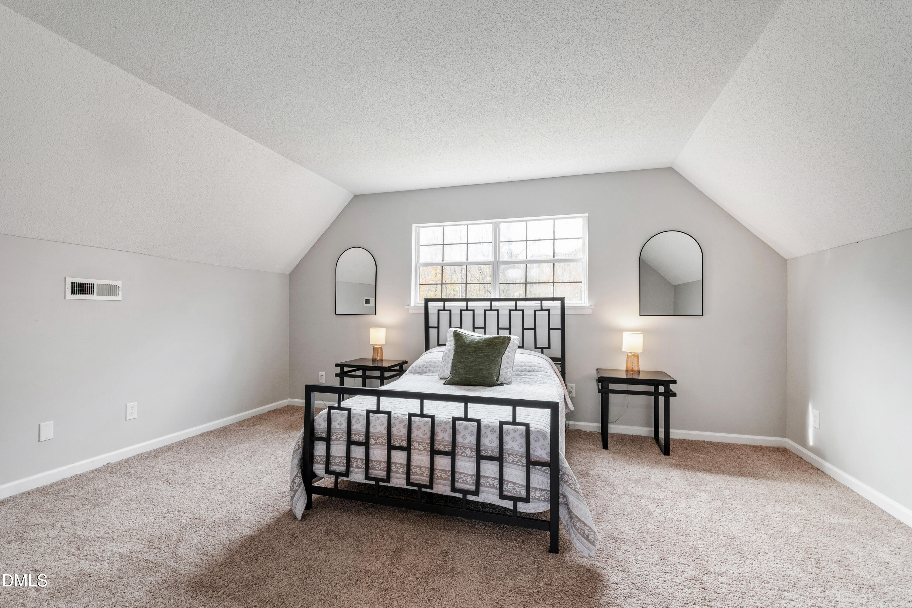 705 Felicia Street Durham, NC 27704 - Photo 21 of 37 a bedroom with a bed lamp and a window