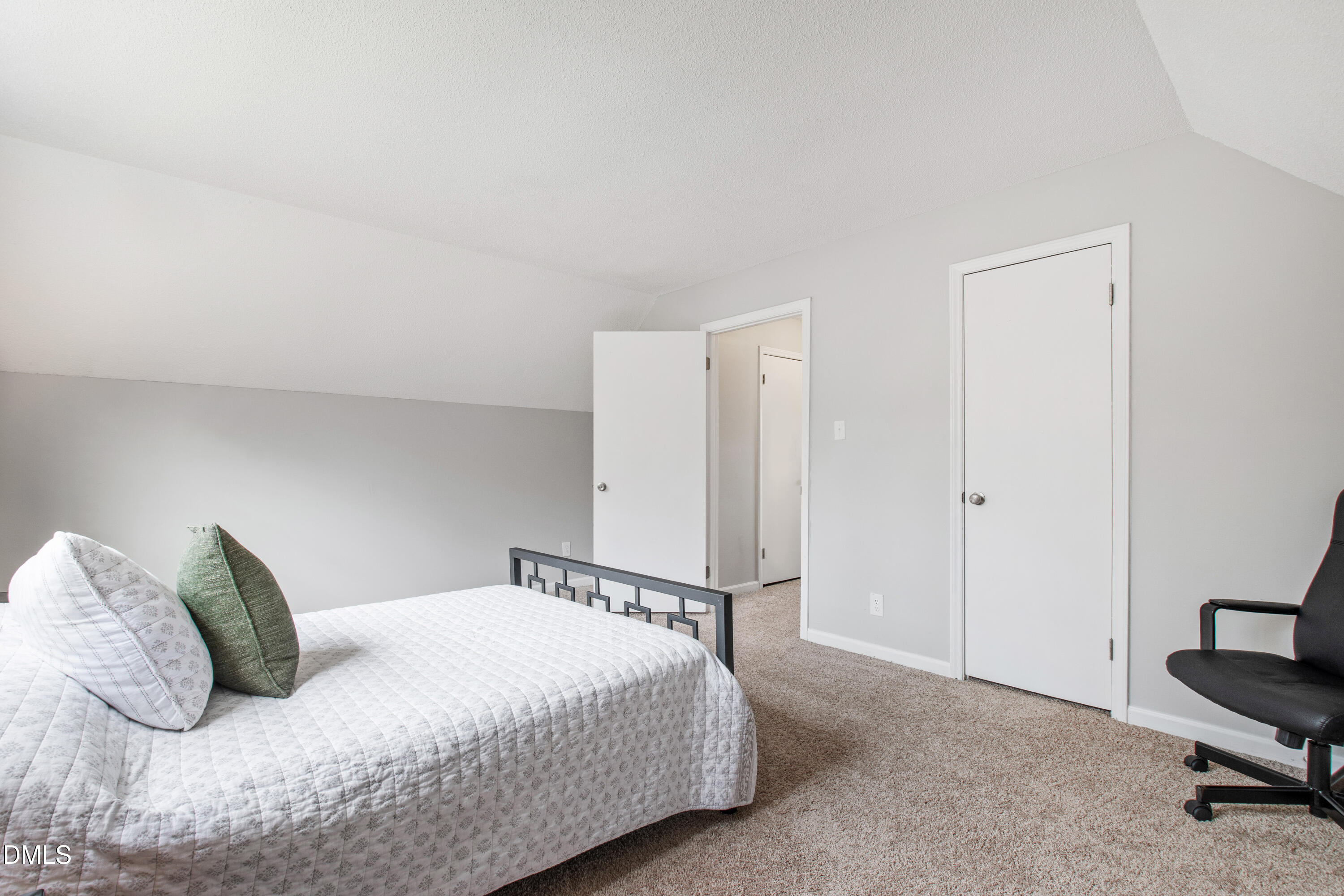 705 Felicia Street Durham, NC 27704 - Photo 22 of 37 a bedroom with a bed and a chair