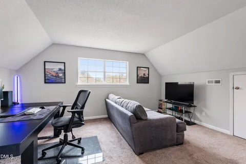a view of a livingroom with workspace and a couch