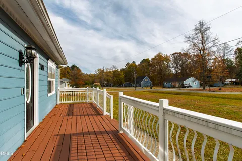 a view of balcony with wooden floor and fence