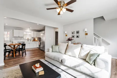 a living room with furniture and kitchen view