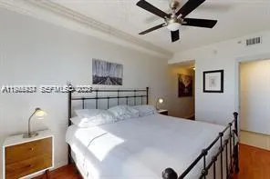 a bed sitting in a bedroom and table