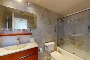 a bathroom with a sink toilet a mirror and shower