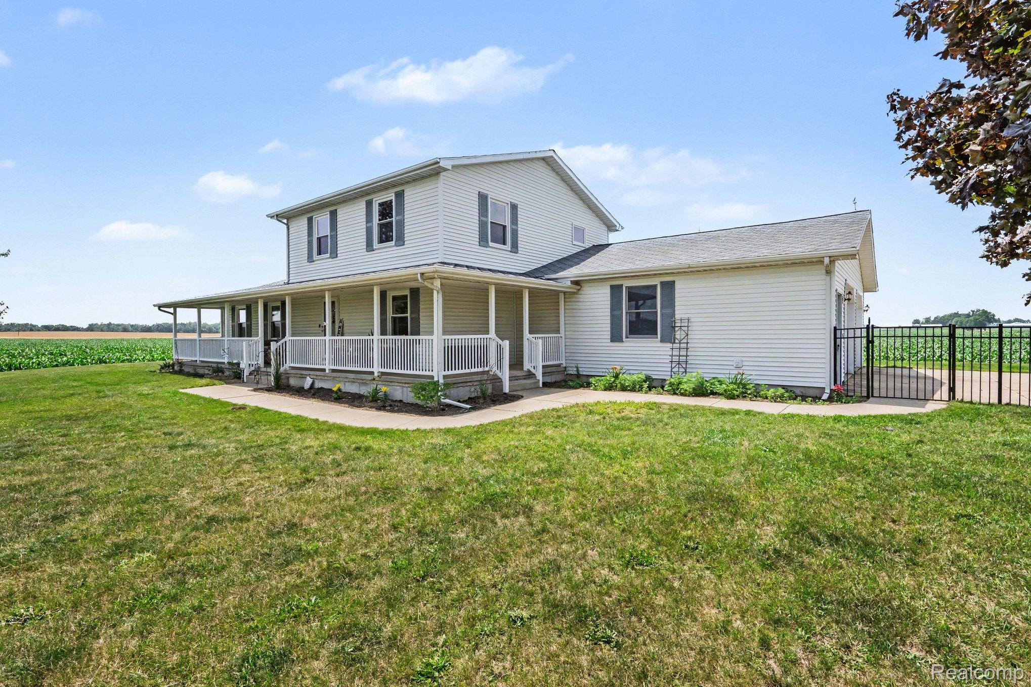 996 Arbogast Road Union City, MI 49094 - Photo 3 of 34 Two-story residence featuring white siding and a wrap-around porch