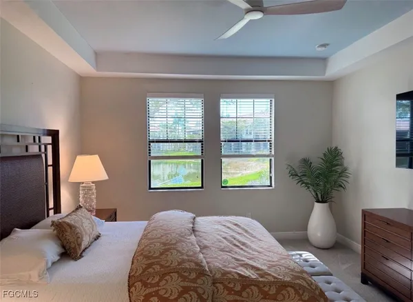 a bedroom with a bed potted plant and a window