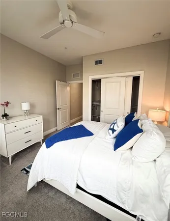 a bedroom with bed and a chandelier