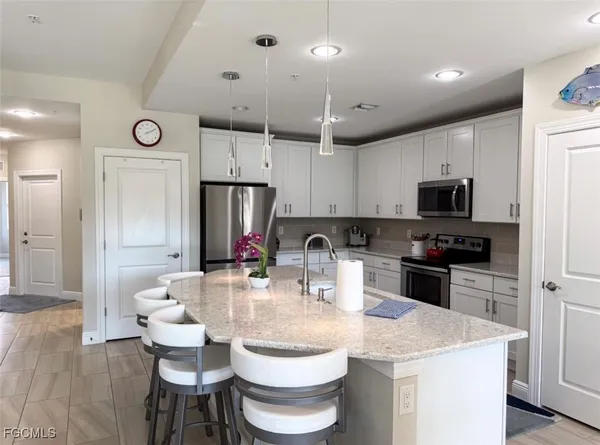 a kitchen with a sink stove and refrigerator