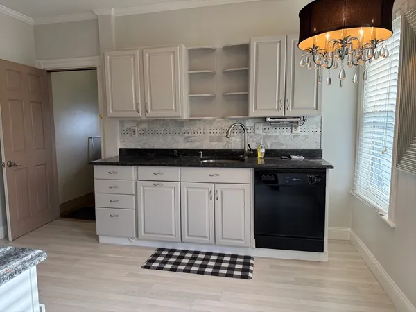 a kitchen with stainless steel appliances granite countertop a stove a refrigerator and a sink