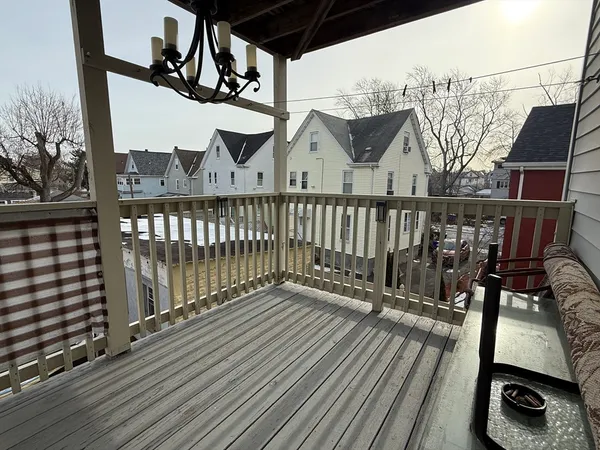 a view of balcony with wooden floor and outdoor seating
