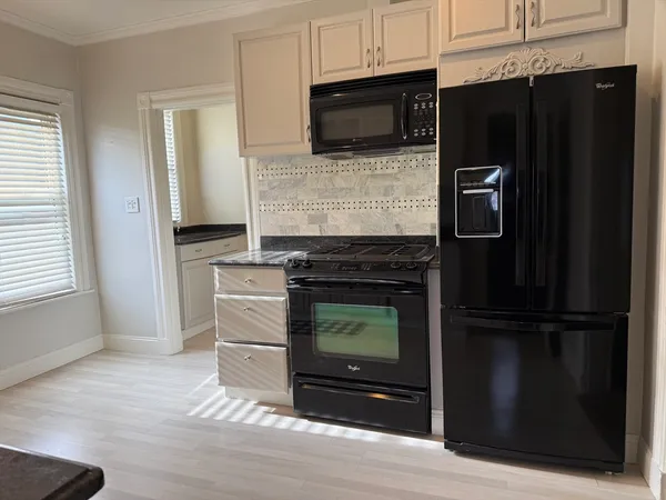 a kitchen with granite countertop stainless steel appliances and cabinets