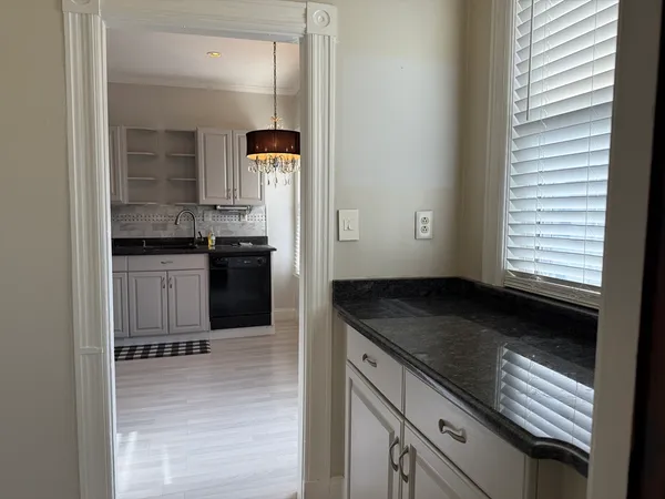 a kitchen with granite countertop a stove and cabinets
